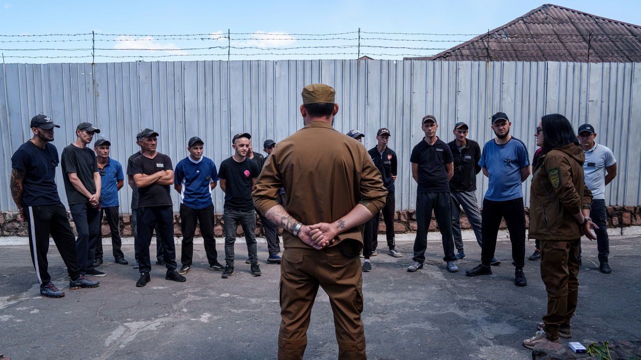 Prisoners listen to a Ukrainian sergeant of the Battalion Arey during an interview in a prison, in the Dnipropetrovsk region, Ukraine