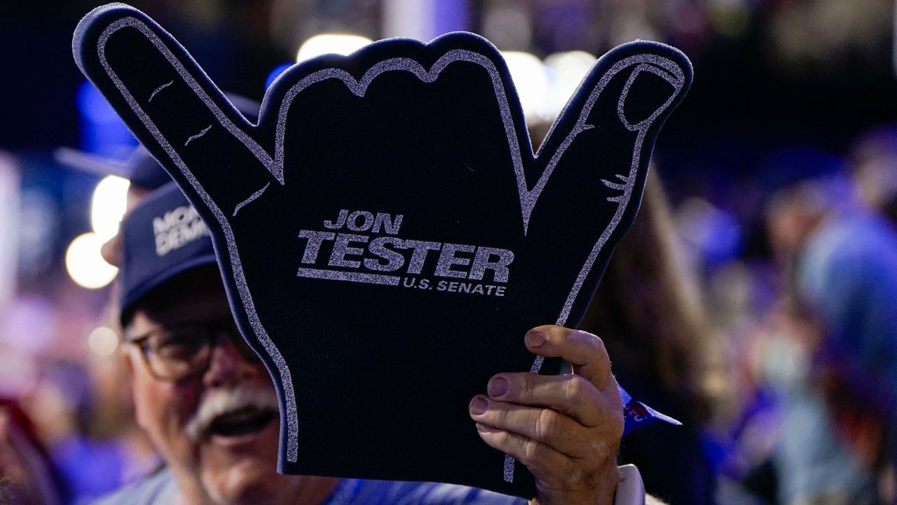 A delegate waves a Jon Tester sign at the Democratic National Convention