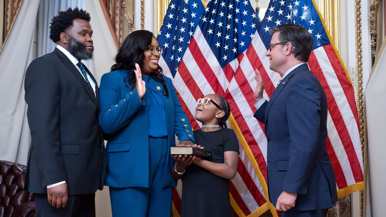 Speaker of the House Mike Johnson administers the oath of office to Rep. LaMonica McIver, as she is joined by her husband and daughter at a ceremonial swearing-in, at the Capitol in Washington.