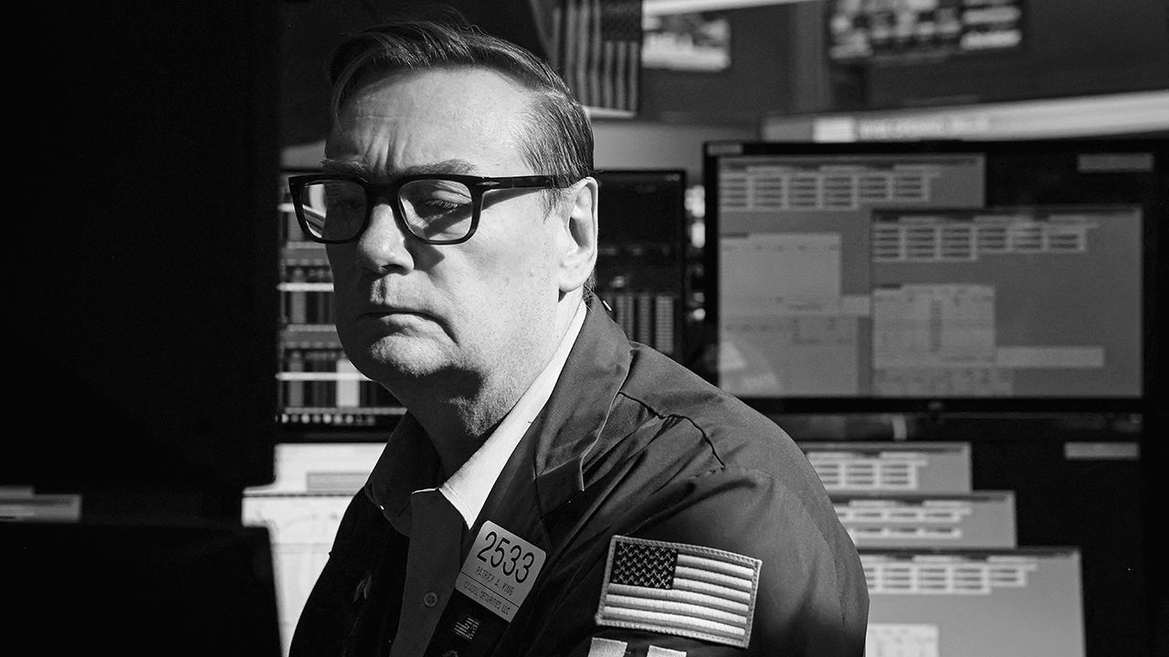 A trader works at his post on the floor at the New York Stock Exchange.